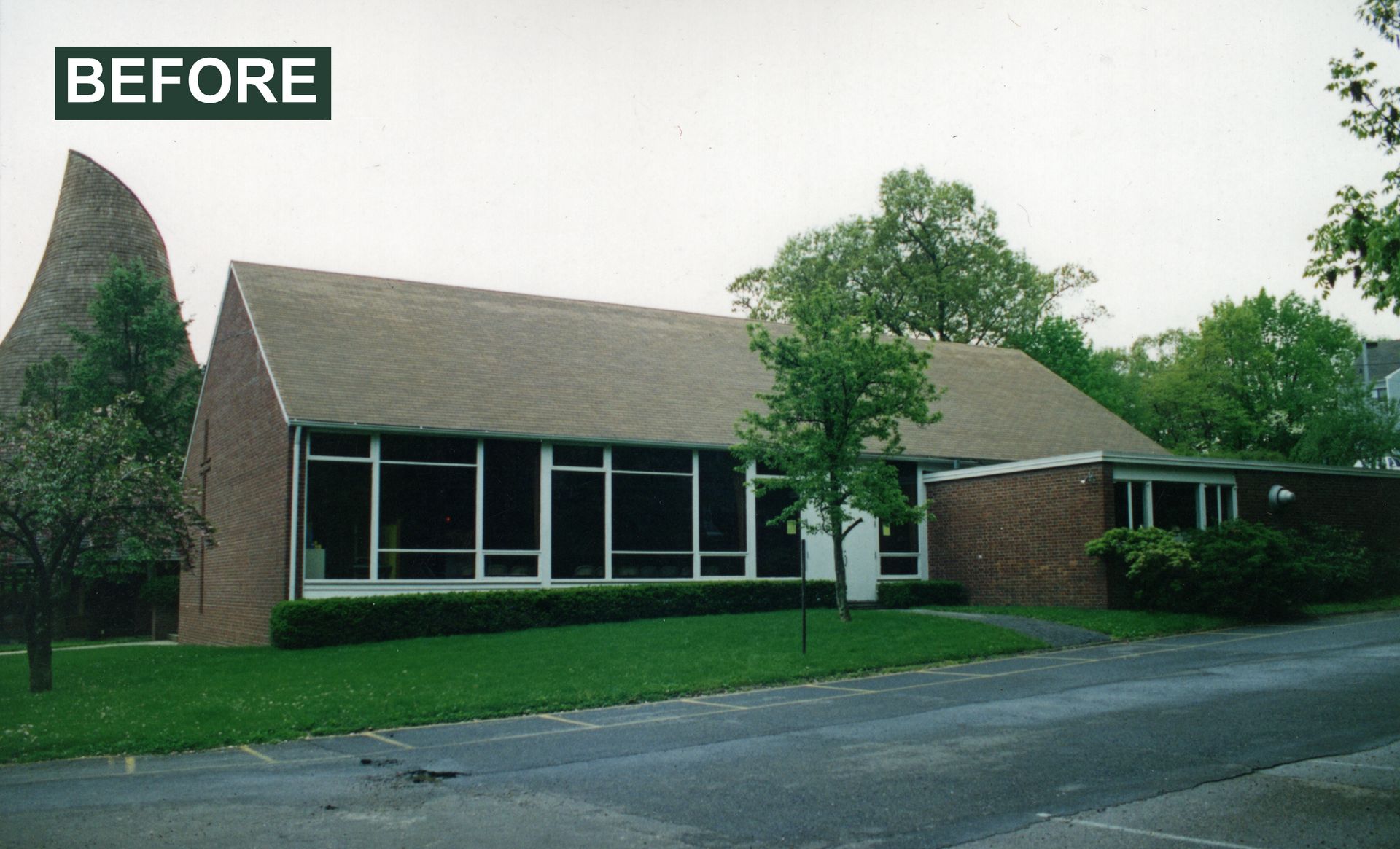Brick building with sloping roof and large windows, 