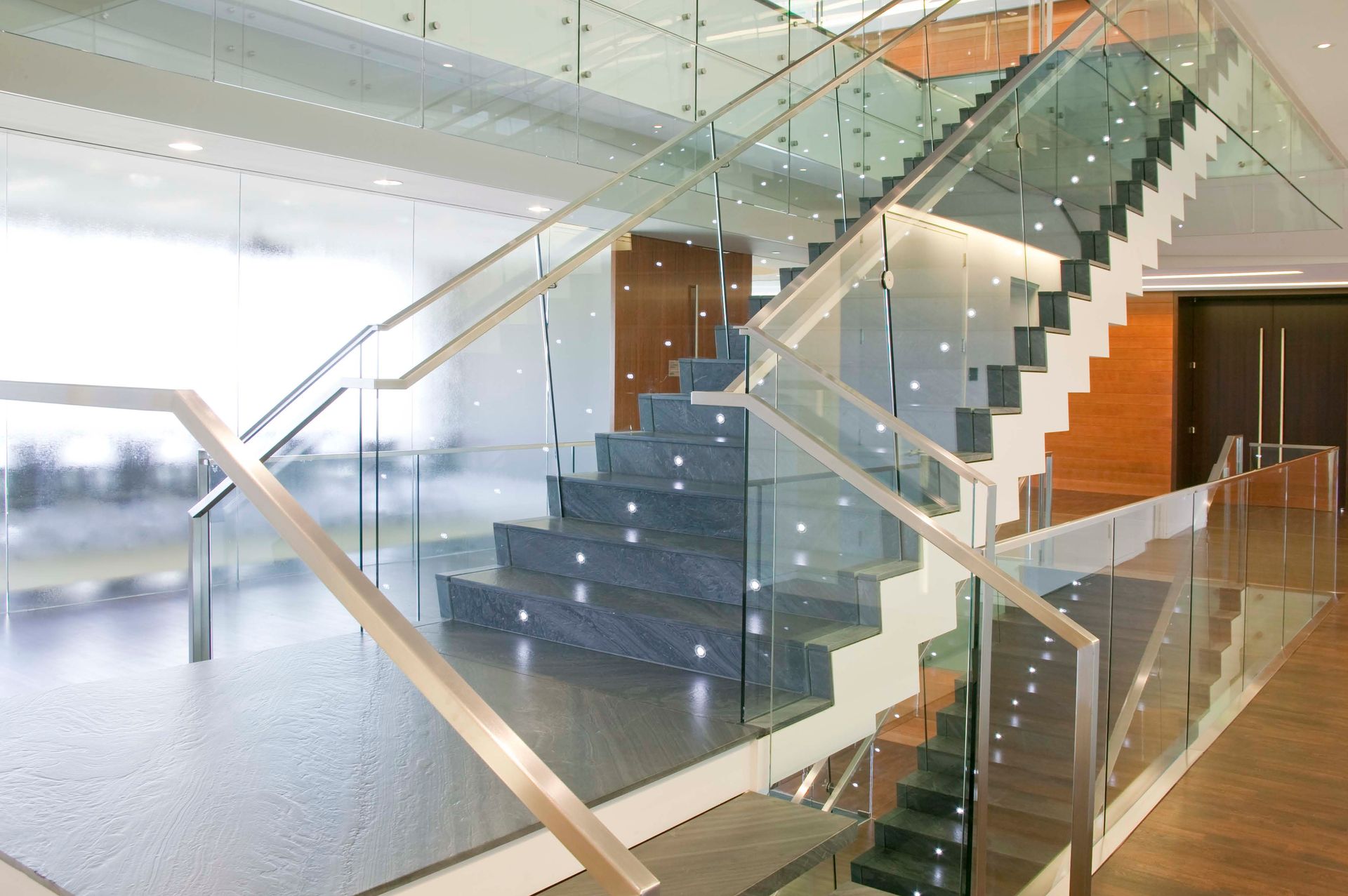 A staircase with a glass railing in a building