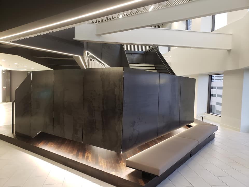 A room with a staircase and a bench in it