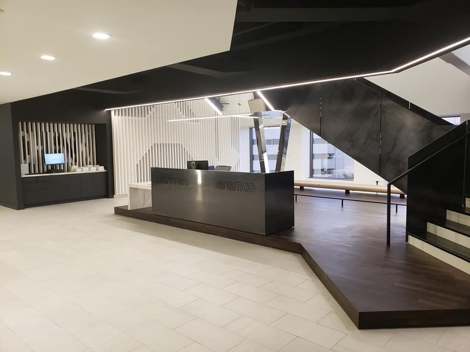 A lobby with a staircase and a reception desk