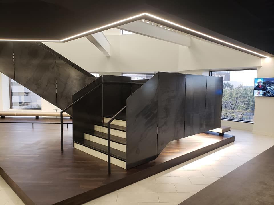 A staircase in a room with a tv on the wall