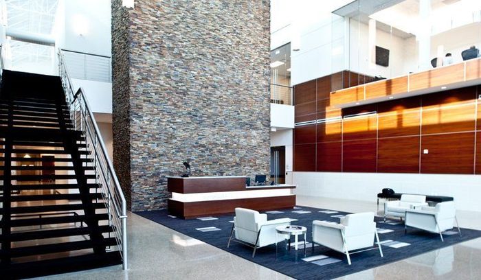 A Lobby with A Staircase and A Reception Desk