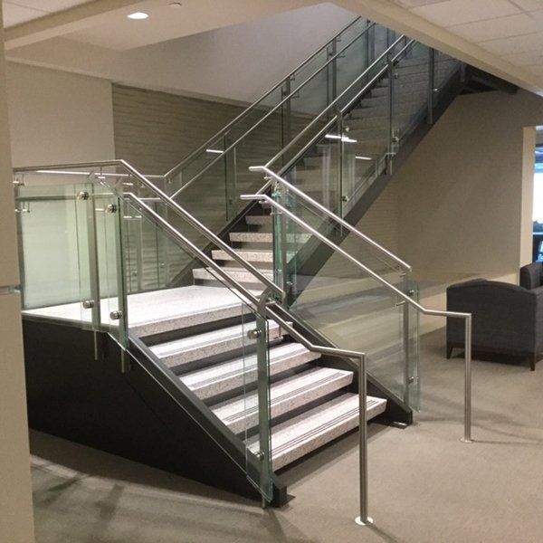 A Staircase with A Glass Railing in A Building