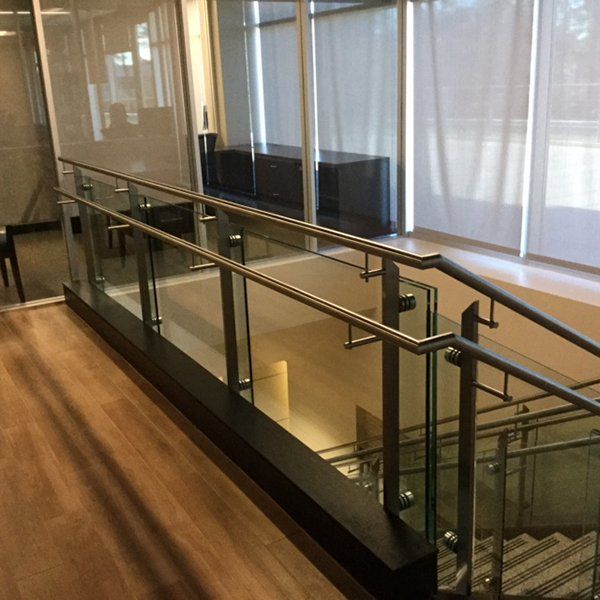 A Staircase with A Glass Railing in A Building