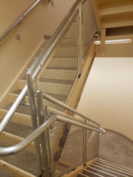 A Staircase with A Metal Railing and Wooden Steps