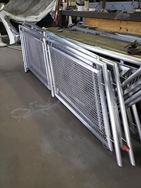 A Bunch of Metal Fences Are Stacked on Top of Each Other in A Room