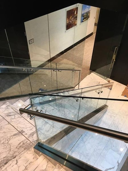 A Staircase with A Glass Railing in A Building