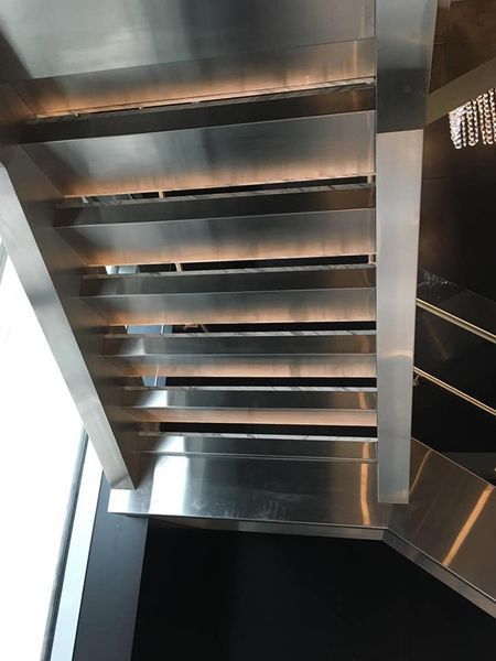 A Close up Of a Stainless Steel Staircase in A Building