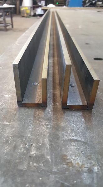 Two Pieces of Metal Are Sitting Next to Each Other on A Table