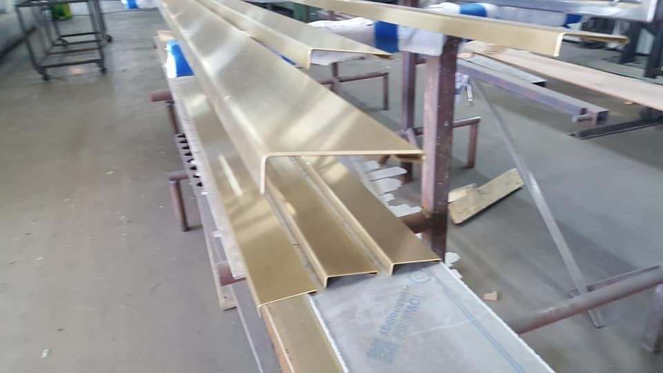 A Bunch of Metal Pieces Are Sitting on Top of Each Other on A Table