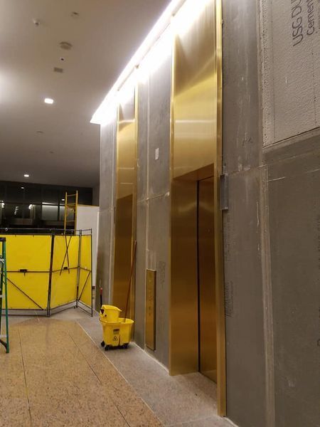 A Hallway with Elevators and A Sign that Says 'clean' on It