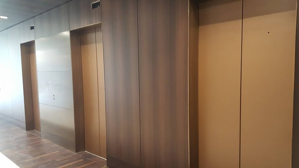 A Row of Elevators in A Building with Wooden Doors