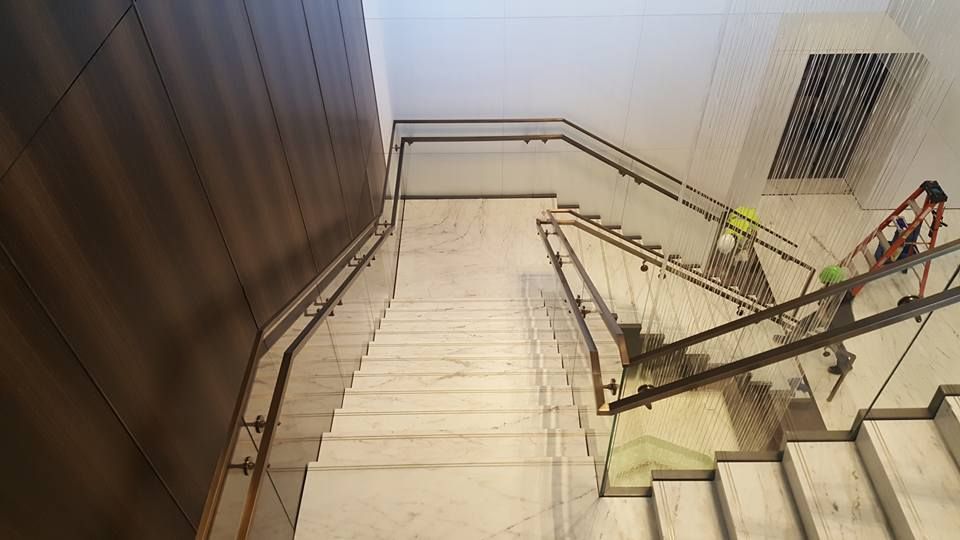 A Staircase with A Glass Railing in A Building Under Construction