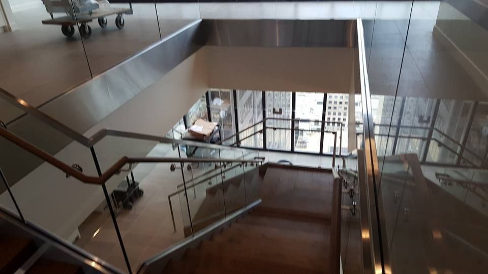 A Staircase with A Glass Railing in A Building