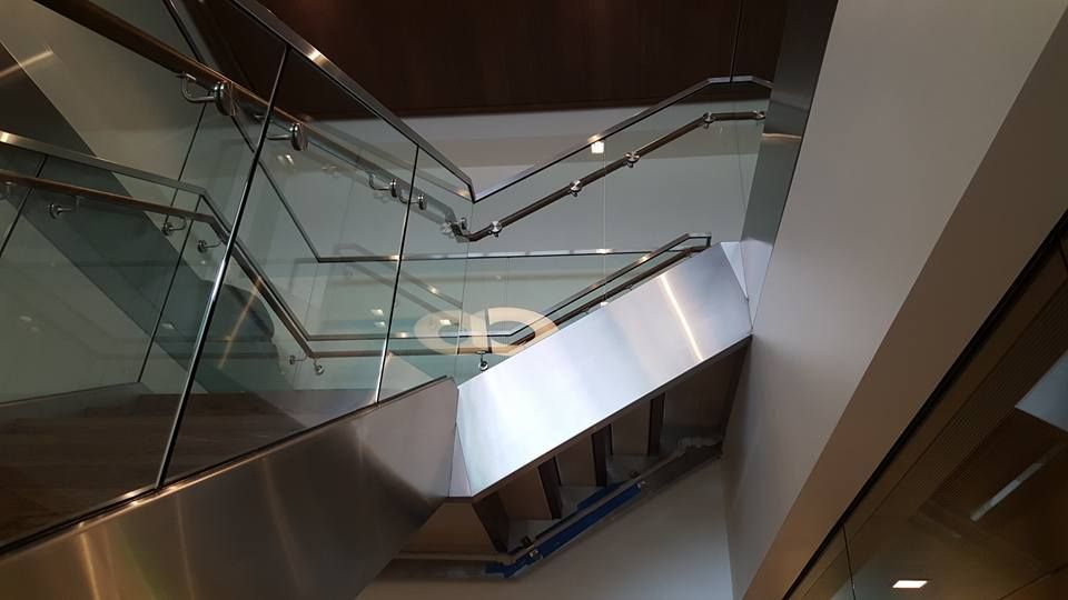 A Staircase with A Glass Railing and A Stainless Steel Railing