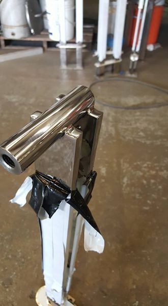 A Stainless Steel Pipe Is Sitting on Top of A Wooden Table