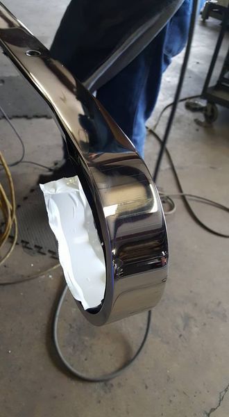 A Person Is Welding a Piece of Metal in A Garage