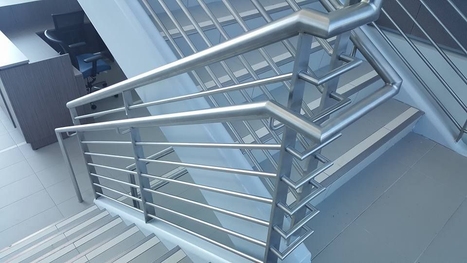 A Staircase with A Stainless Steel Railing in A Building