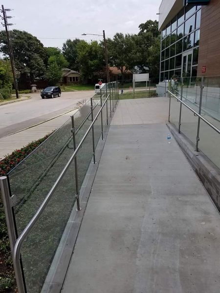 A Ramp with A Glass Railing Leading to A Building