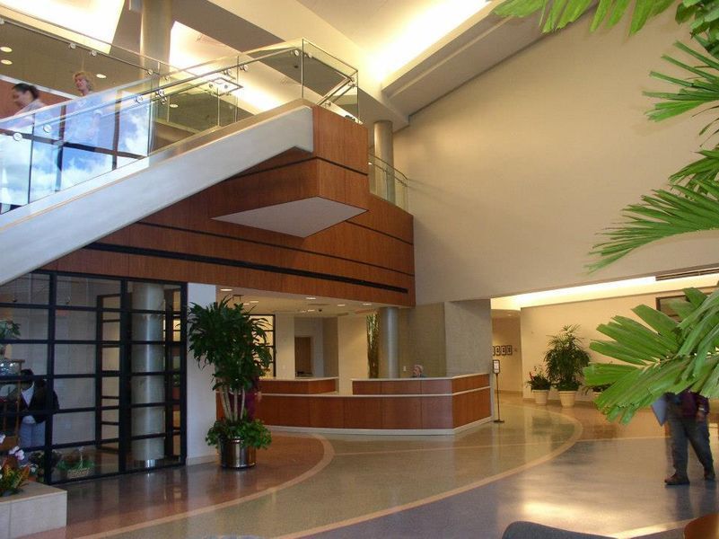 A Large Lobby with Stairs and A Reception Desk