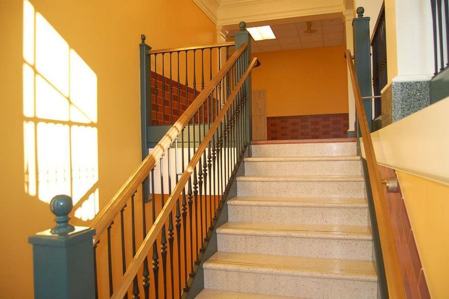 A Set of Stairs with A Wrought Iron Railing
