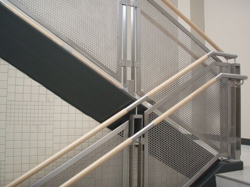 A Staircase with A Metal Railing and Wooden Handrails