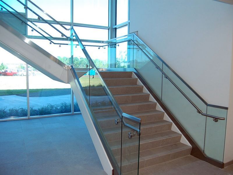 A Staircase with A Glass Railing in A Building