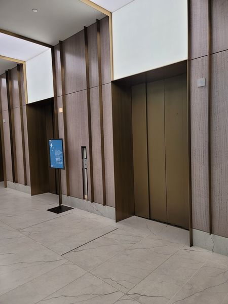 A Hallway with Two Elevators in A Building