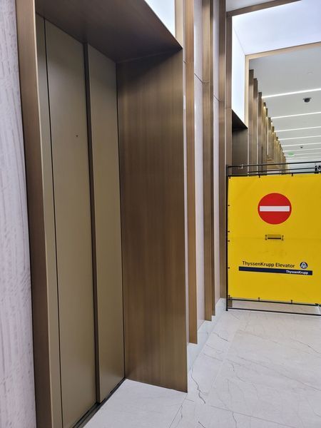 An Elevator with A Yellow Sign that Says Do Not Enter
