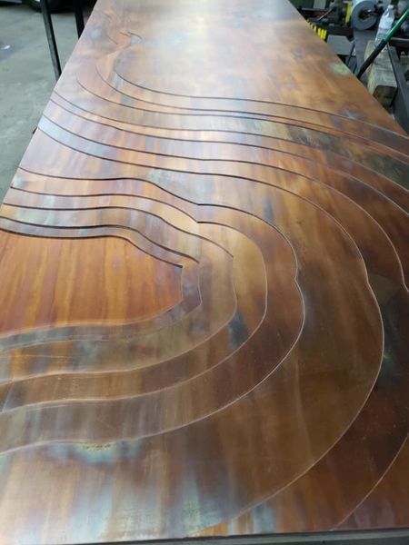 A Wooden Table with A Curved Pattern on It