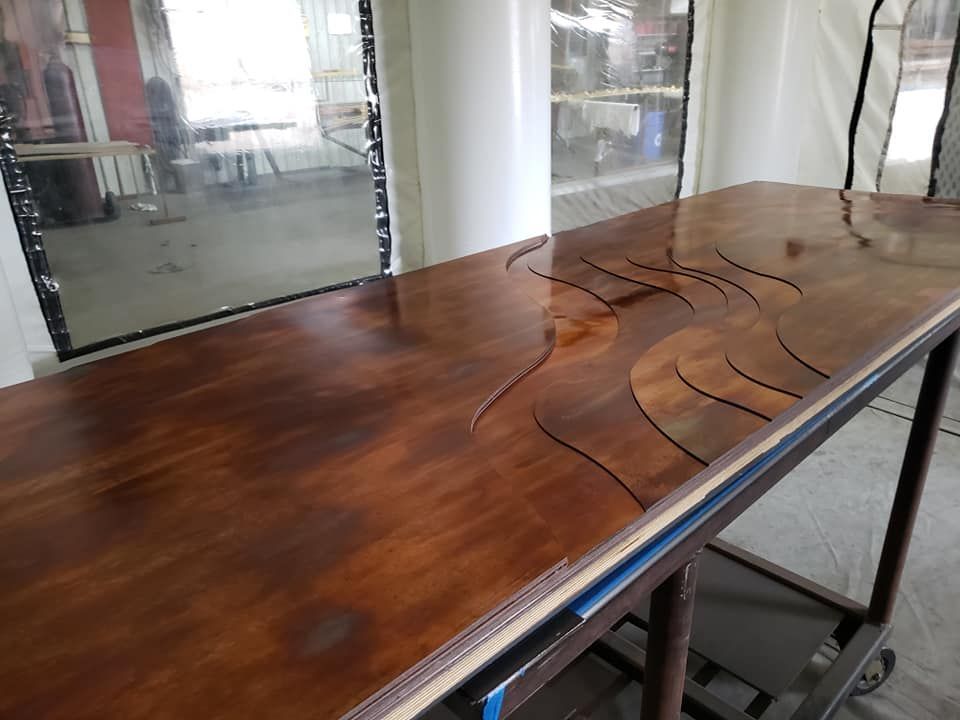 A Wooden Table Is Sitting on A Cart in A Room