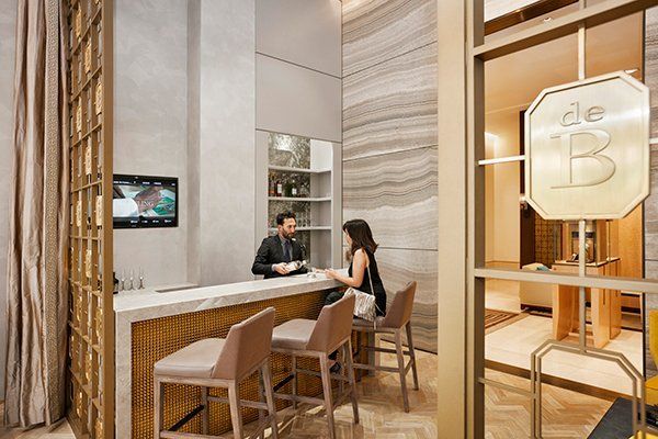 A Man and A Woman Are Sitting at A Counter in A Room