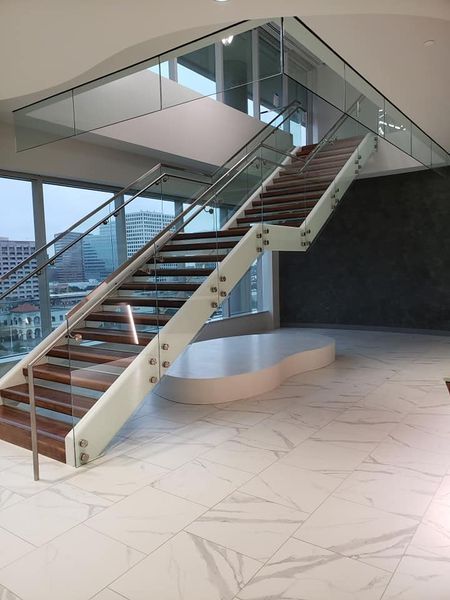 A Staircase with A Glass Railing and Wooden Steps