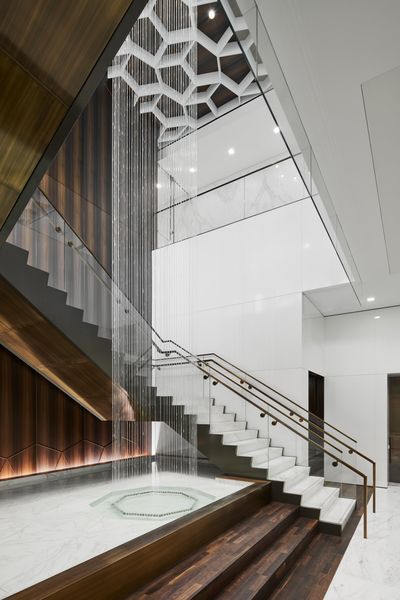 A Staircase in A Building with A Glass Railing