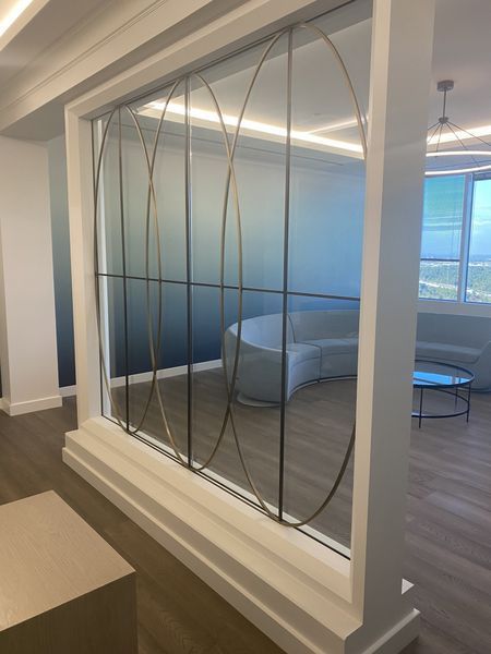 A Room with A Couch and A Table Behind a Glass Wall