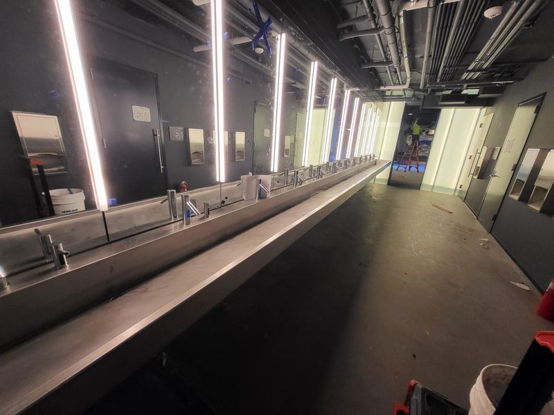 A Long Bathroom with A Lot of Sinks and Mirrors