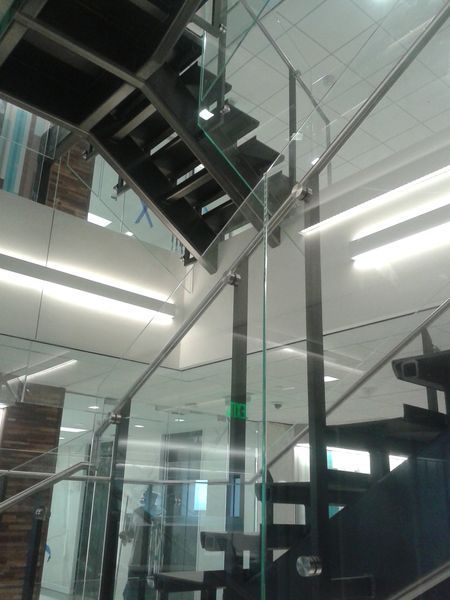 A Staircase with A Glass Railing in A Building