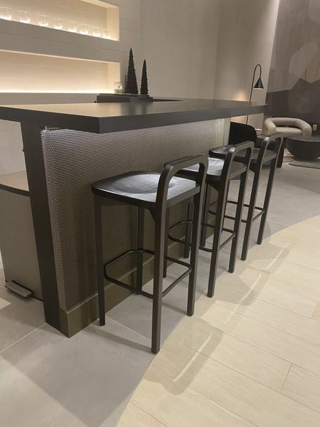 A Row of Bar Stools Next to A Table in A Living Room