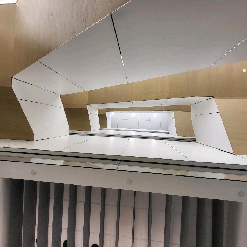 A staircase with a wooden ceiling and white walls