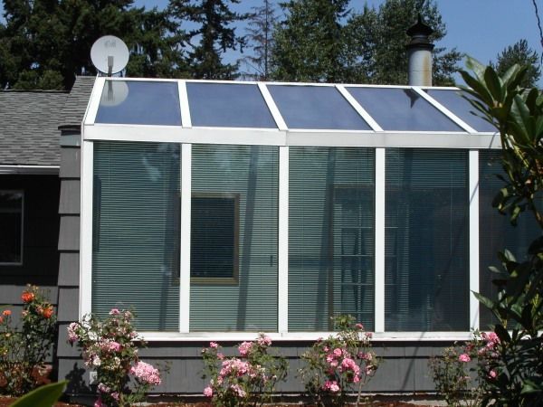A greenhouse with a satellite dish on top of it