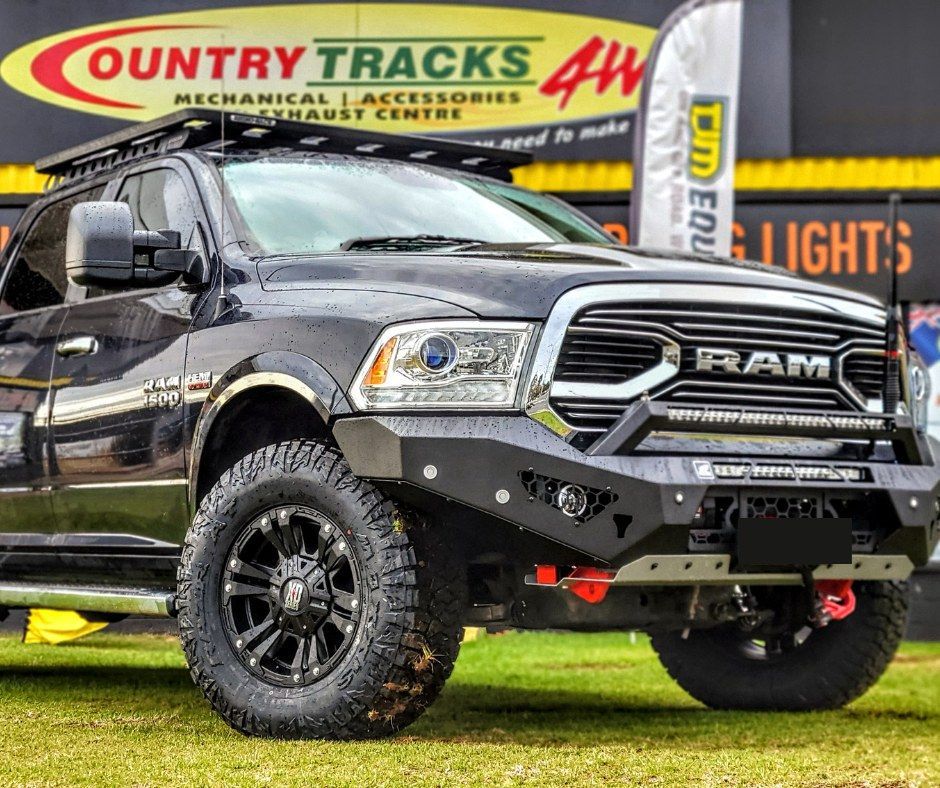 Storefront sign for Country Tracks and Swan Hill Exhaust Centre. Displays welcome message and 4x4 store.