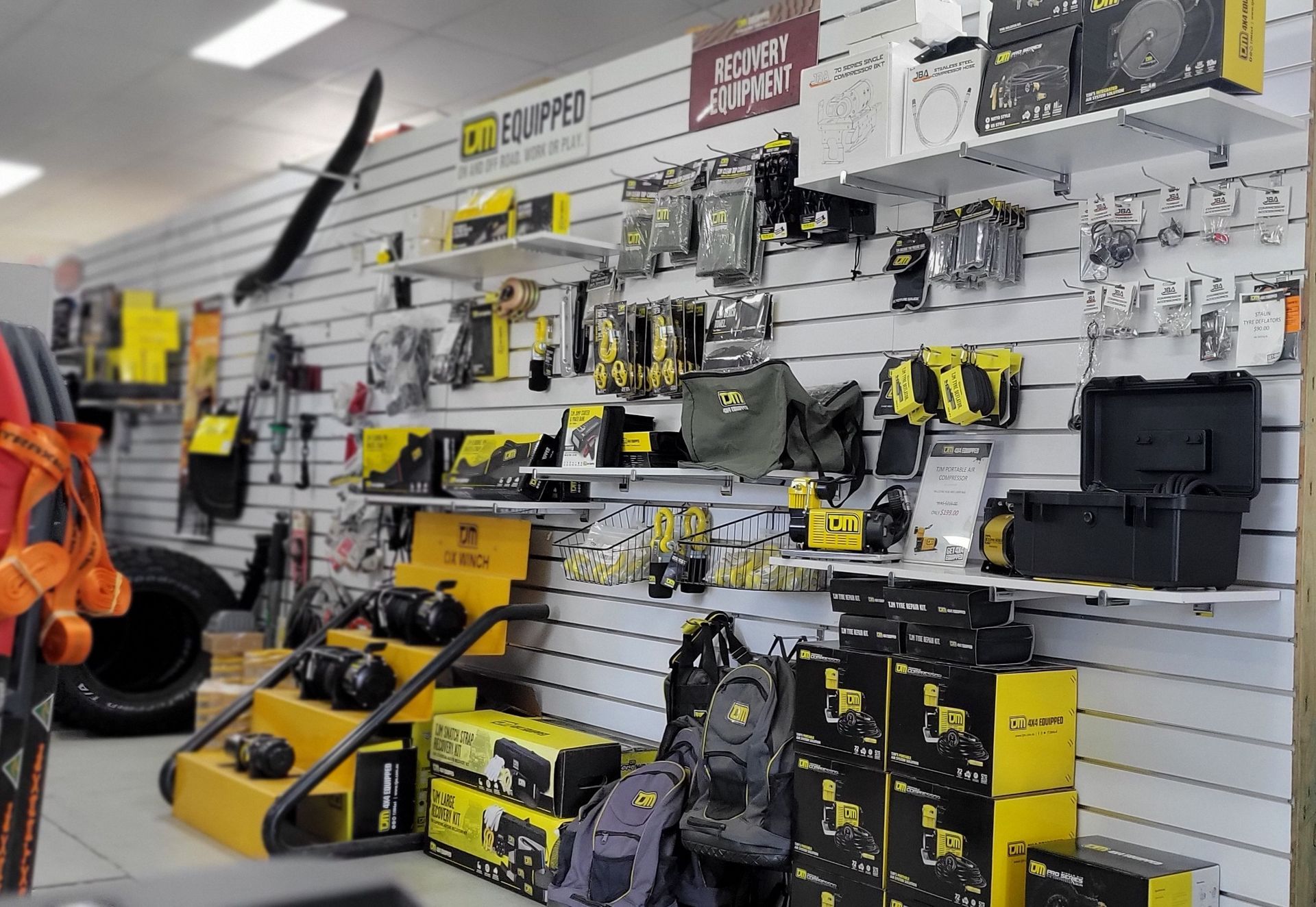 Metal engine parts arranged on a pegboard, likely in a shop.