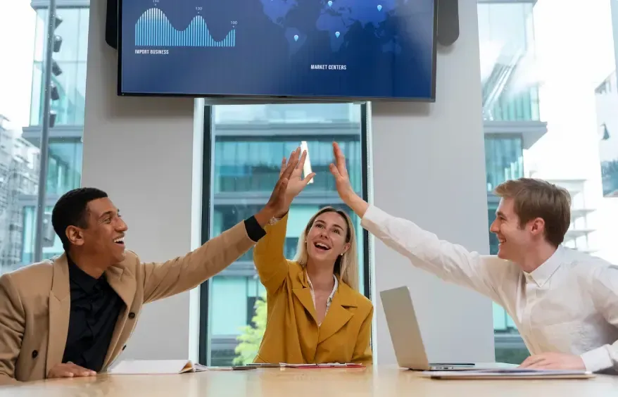 Happy clients high-fiving each other for digital marketing services from Florida Coast SEO.