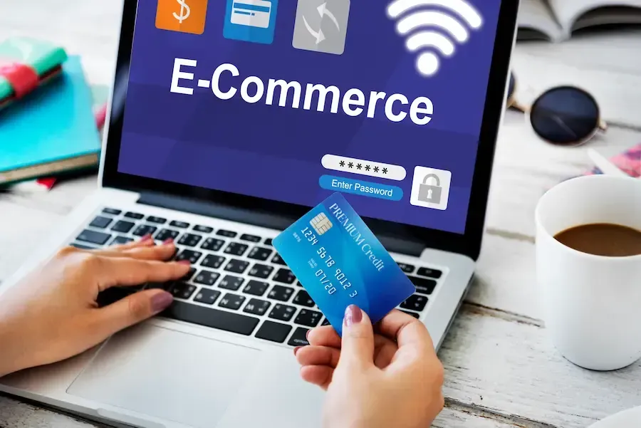 Holding a credit card in front of an e-commerce screen. Florida Coast SEO e-commerce services.