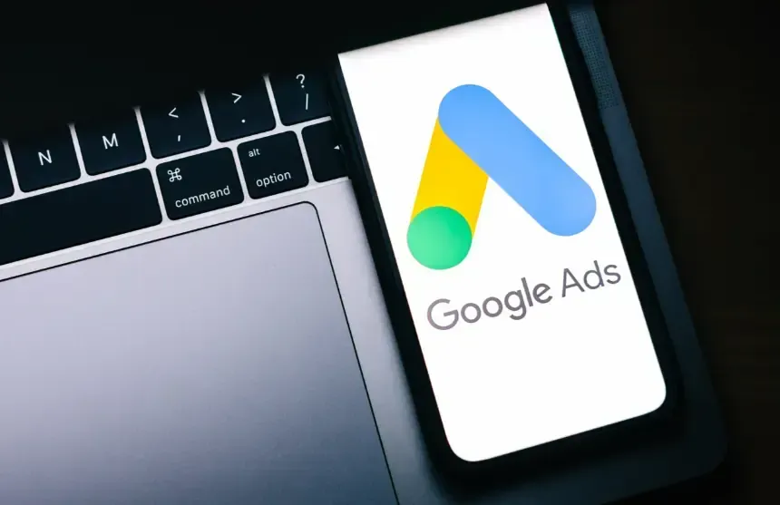 Cell phone on a computer keyboard displaying Google Ads. Florida Coast SEO provides Google Ads  services.