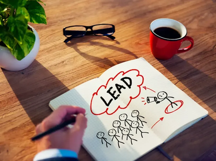 Person writing in notebook about lead generation, a service Florida Coast SEO provides.