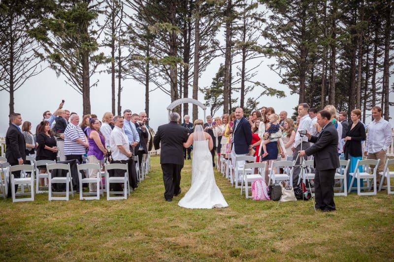 A bride and groom are walking down the aisle at their wedding ceremony.