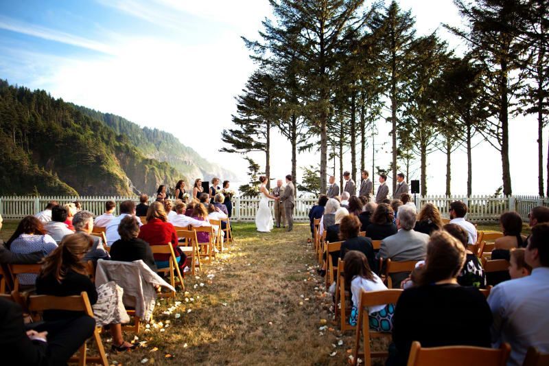A bride and groom are getting married in front of a crowd of people