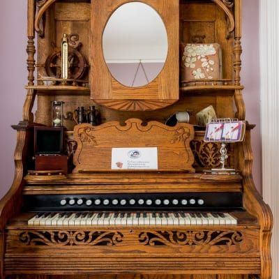 A piano with a mirror on top of it