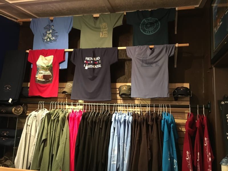 A row of shirts hanging on a rack with one that says i 'm not a hipster